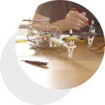 a person sitting at a table with a remote control drone