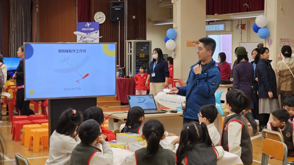 a group of people watching a presentation on a large screen